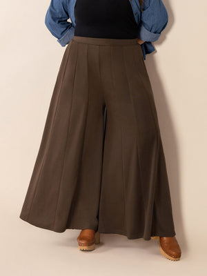 Dark brown sculpted flare palazzo trousers with vertical seam details.