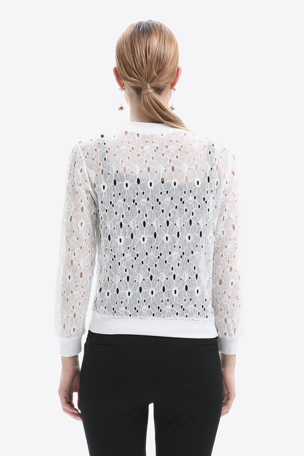 White lace-cut bomber jacket with allover floral eyelet pattern and ribbed cuffs.