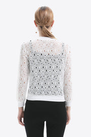 White lace-cut bomber jacket with allover floral eyelet pattern and ribbed cuffs.