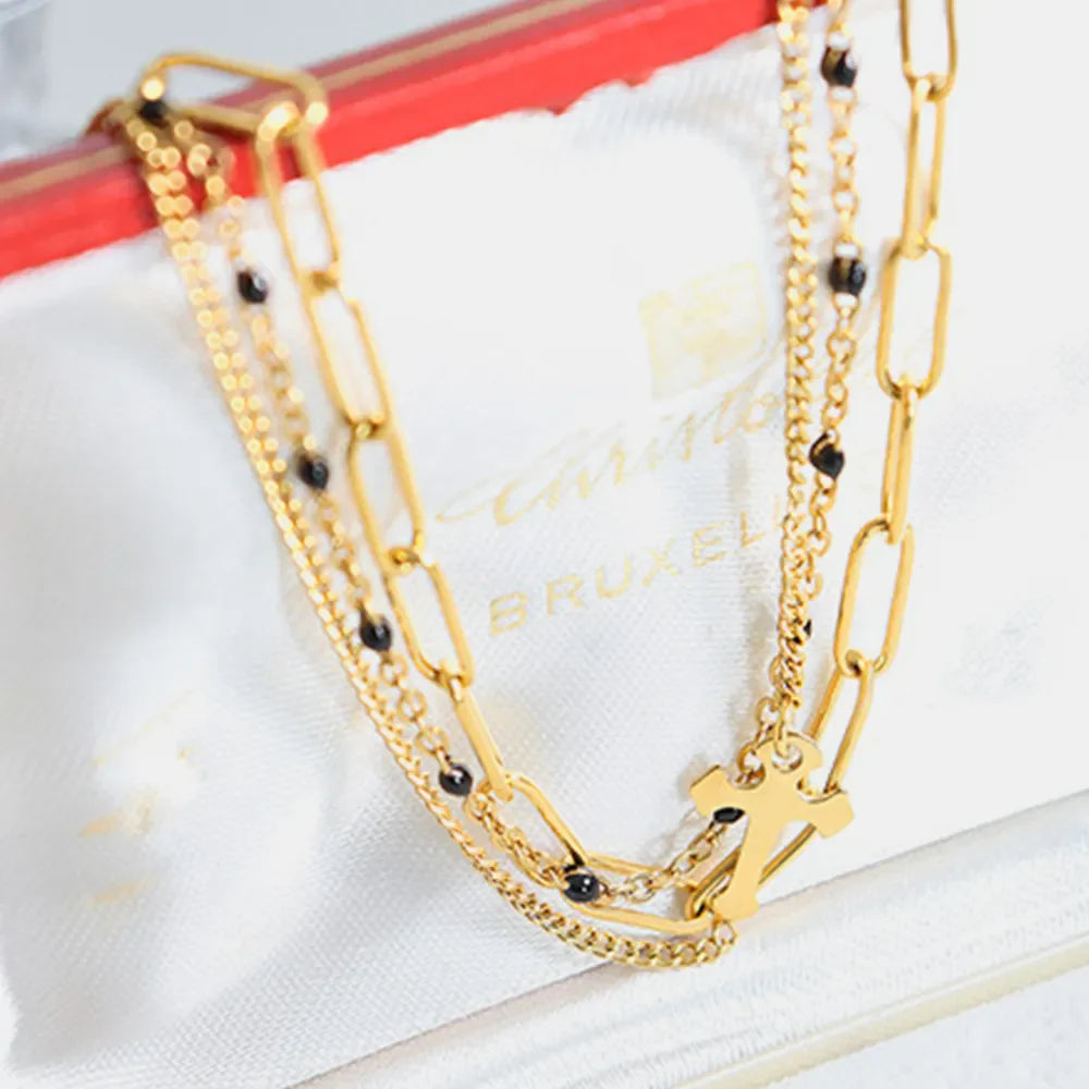Gold layered chain and bead bracelet trio with cross charm
