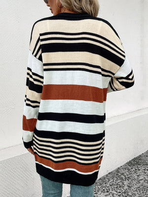 Bold stripe knit duster cardigan with burnt orange, black, white, and cream stripes.