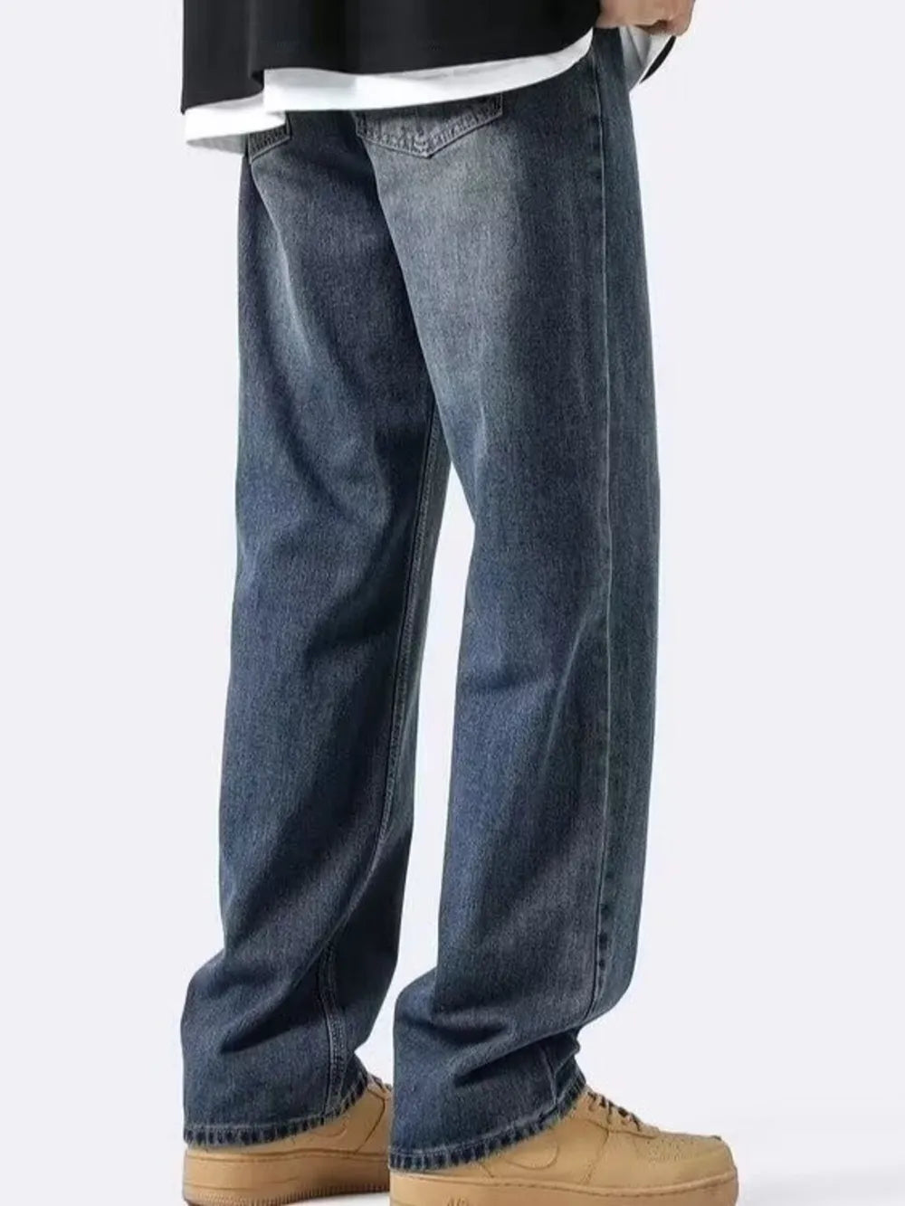 Men's loose-fit vintage wash denim jeans with a relaxed cut.