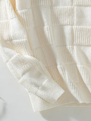 Cream textured checkerboard knit pullover sweater with ribbed cuffs and hem.