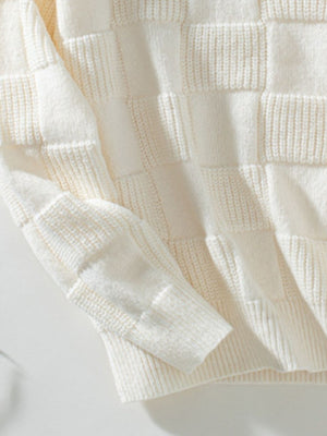 Cream textured checkerboard knit pullover sweater with ribbed cuffs and hem.