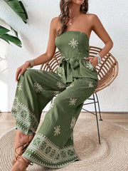 Bandeau jumpsuit in matcha green with white embroidery and wide legs.