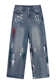Medium wash baggy jeans with artistic paint splatters and distressed details.