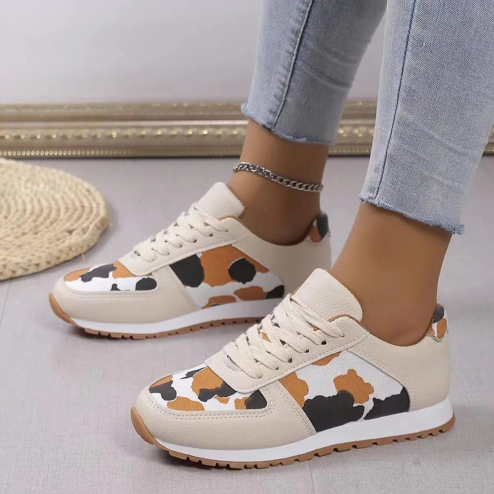 Leopard print panel runner sneakers in ivory with lace-up closure and athletic sole.