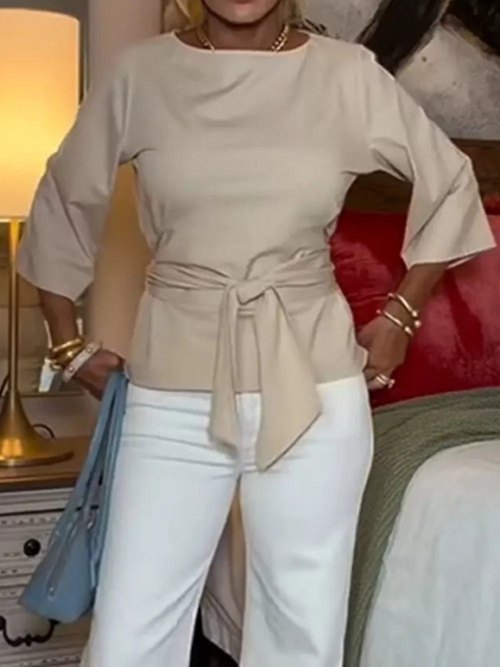 Tied waist t-shirt in off-white with 3/4 sleeves and a boat neckline.