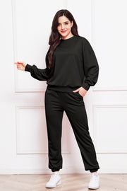 Black relaxed fit loungewear set with crewneck sweatshirt and elastic waist pants.