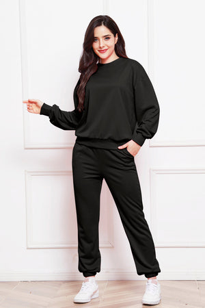 Black relaxed fit loungewear set with crewneck sweatshirt and elastic waist pants.