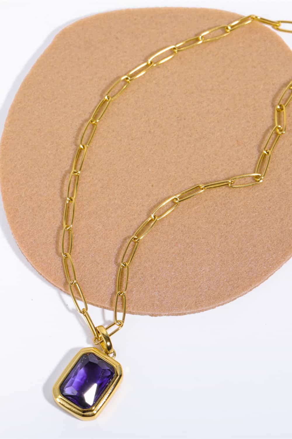 Gilded Prism Pendant Necklace with purple gemstone and 18K gold chain.