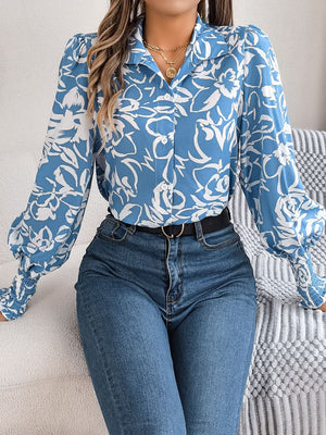 Light blue floral print blouse with shirred cuffs and button front.