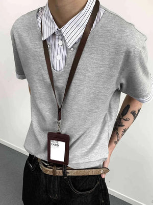 Gray layered polo with striped collar and button placket, cotton blend.