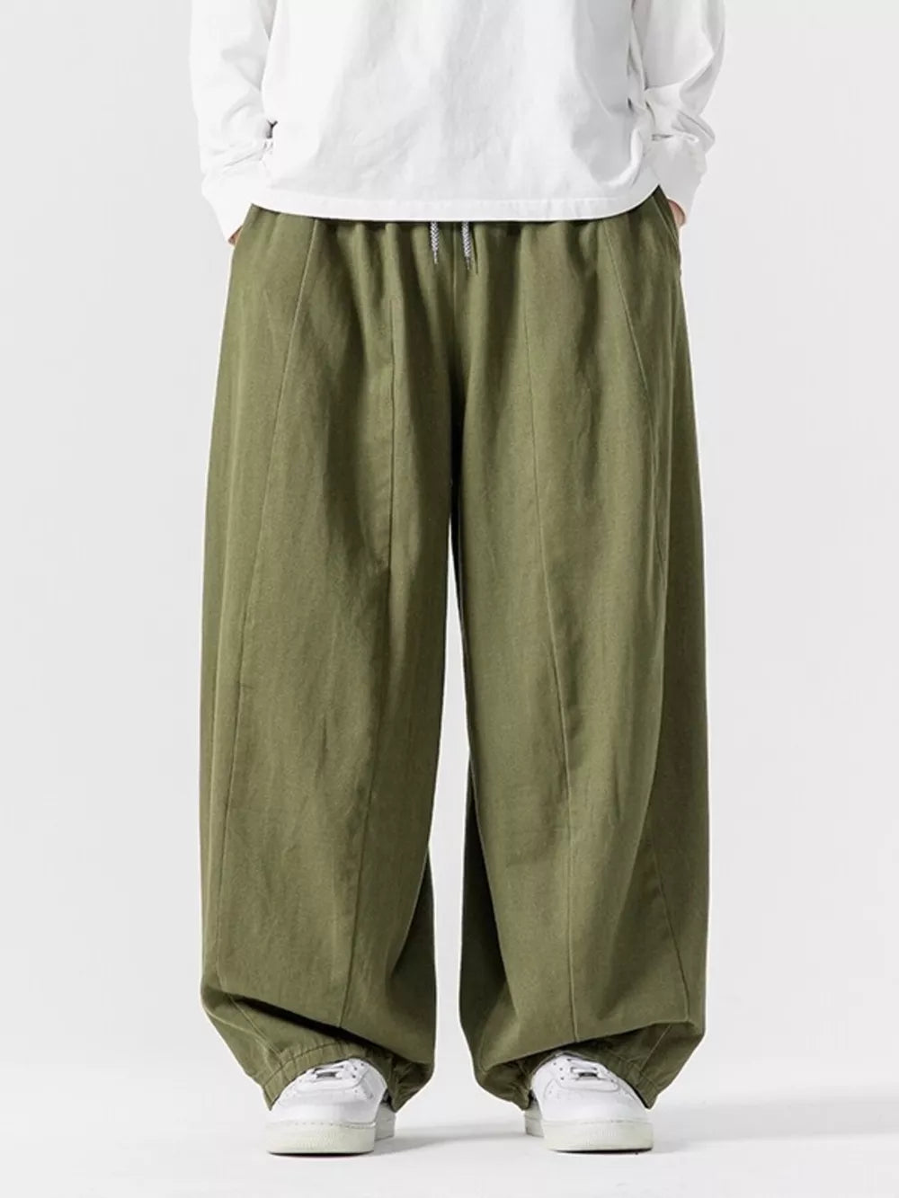 Relaxed fit green sweatpants with drawstring waist and cuffed ankles.