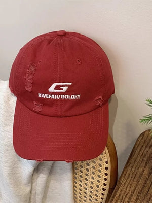 Red cotton baseball hat with distressed details and white embroidery.