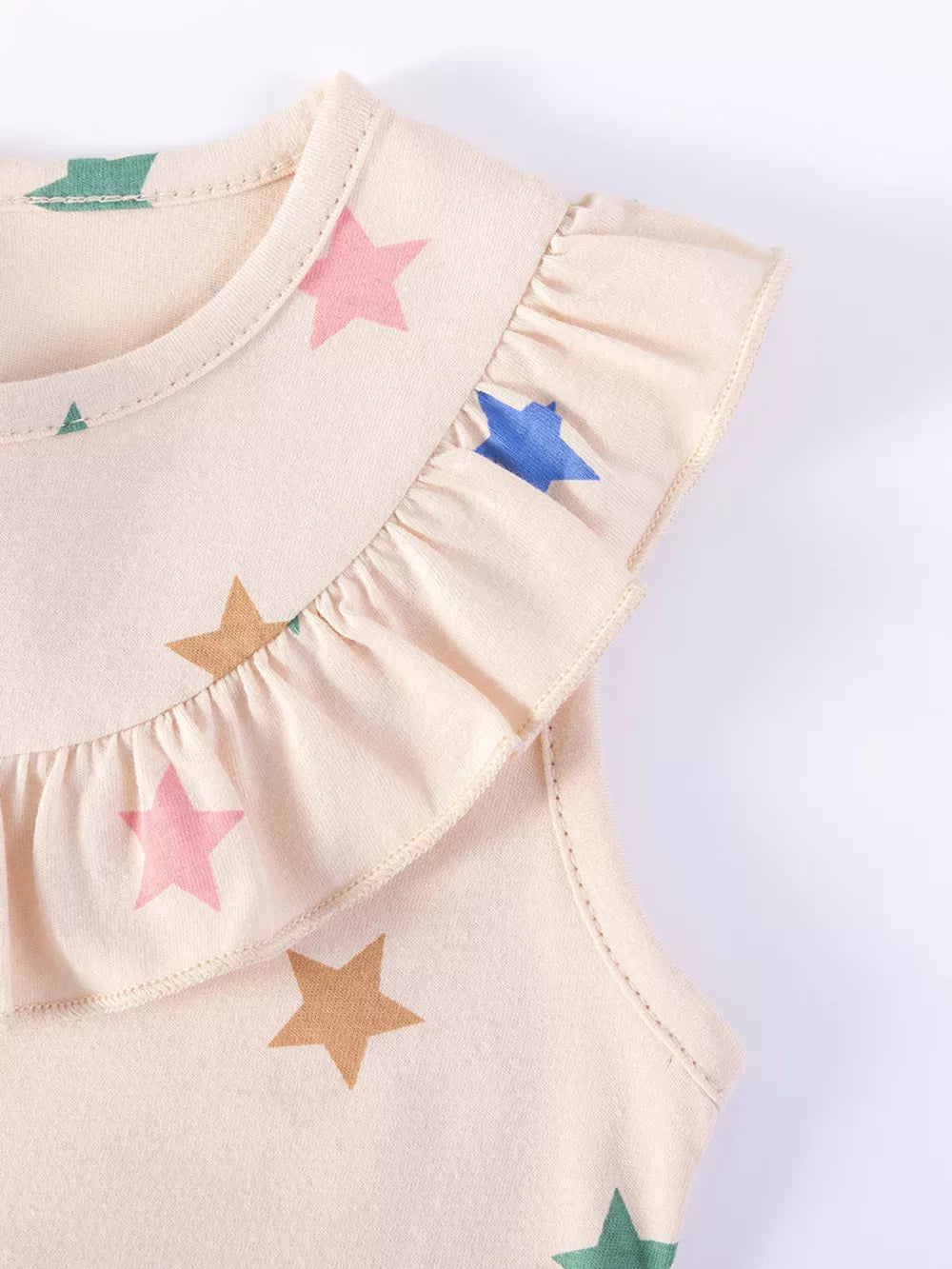 Beige cotton toddler dress with colorful star print and ruffled neckline.