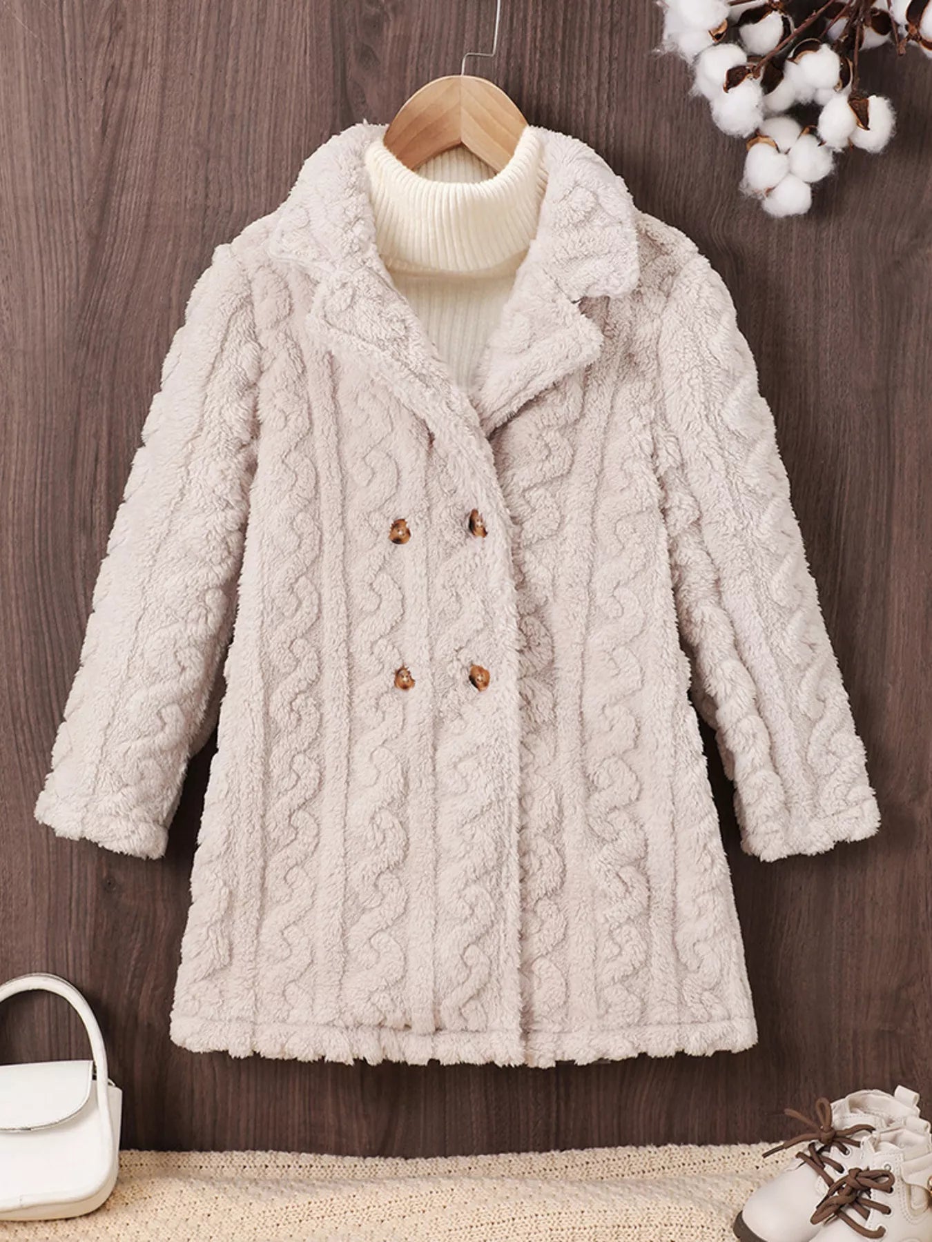Cozy textured double-breasted pea coat in eggshell with cable knit pattern.