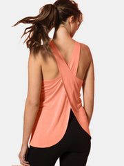 Coral cross-back flow tank top with a split back detail.