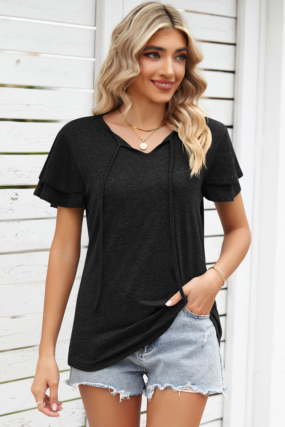 Black flutter sleeve henley tee with tie-neck detail and layered sleeves.