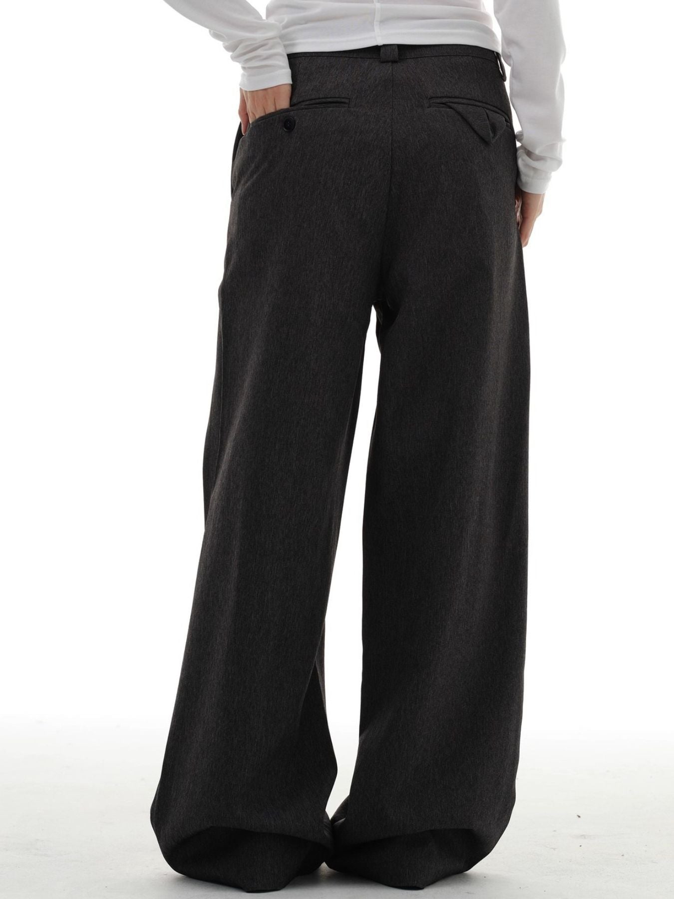 Men's dark grey wide-leg pleated trousers with a relaxed fit and back pockets.