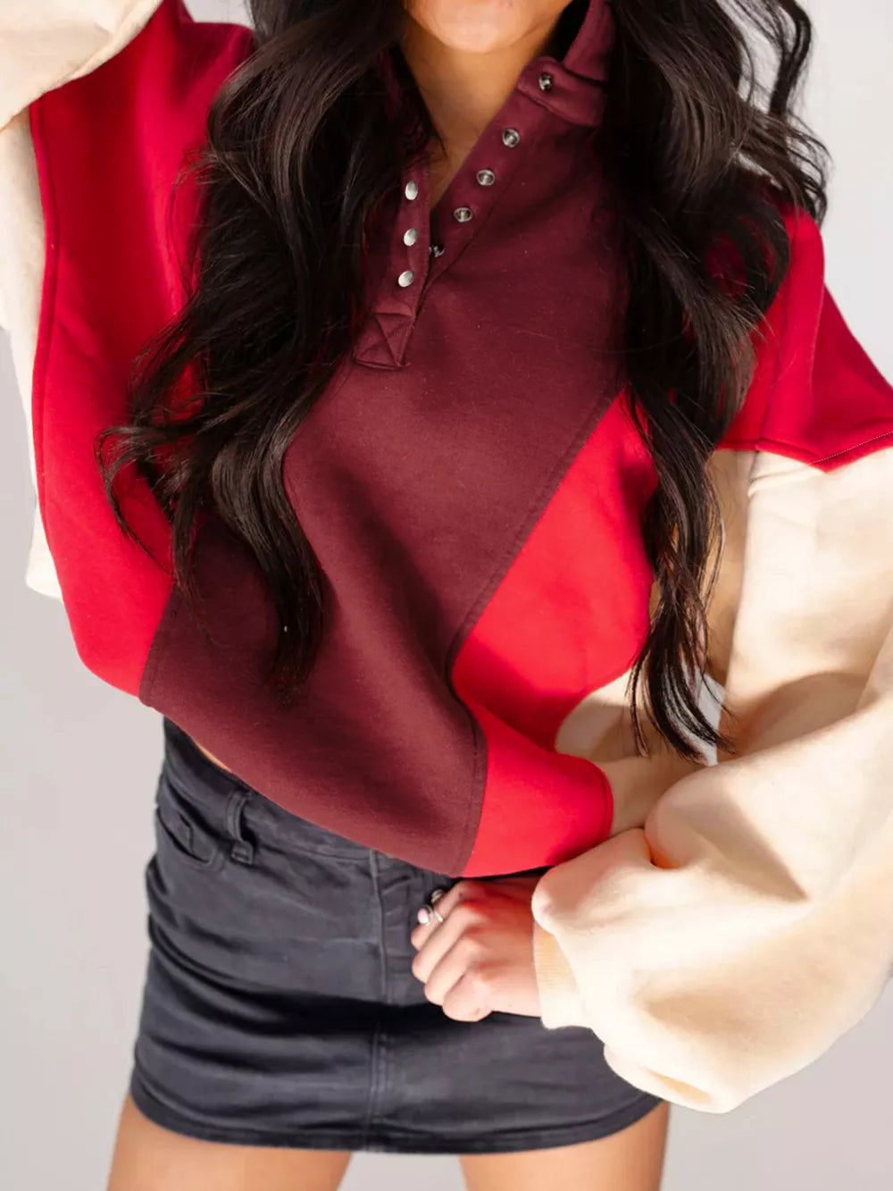 Color block cotton hoodie with button neckline in red, brown, and cream.