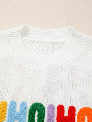 White chenille chunky knit crew neck sweater with colorful fuzzy letters.