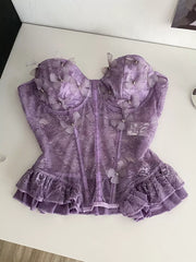 Purple lace bustier top with 3D butterflies, pearl accents, and ruffled hem.