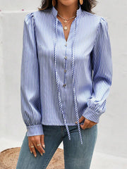 Light blue striped blouse with puffed sleeves, keyhole neckline, and tie detail.