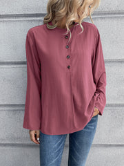 Mandarin collar button-down blouse in a muted rose color with a subtle vertical texture and button placket.