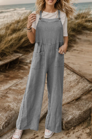 Gray textured cotton overalls with square pockets and wide legs.