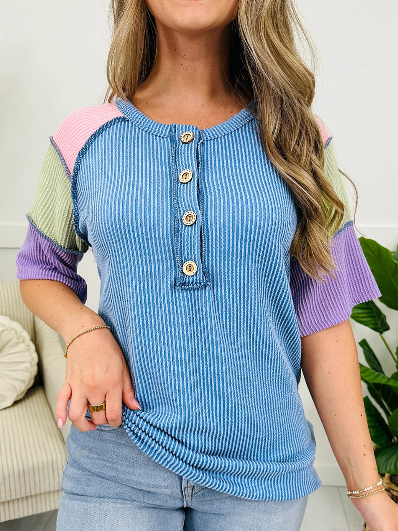 Color block patchwork henley t-shirt with button detail and striped texture.