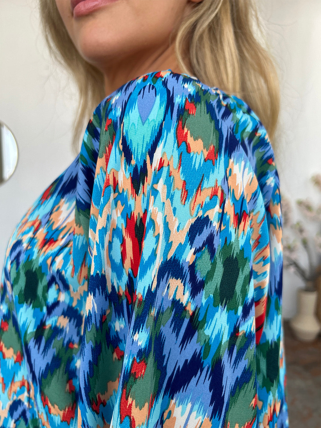 Prismatic ikat blouse in sky blue with voluminous sleeves and a vibrant abstract print.