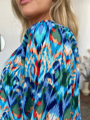 Prismatic ikat blouse in sky blue with voluminous sleeves and a vibrant abstract print.