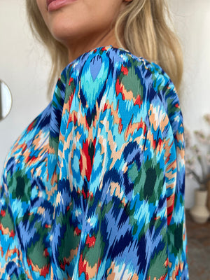 Prismatic ikat blouse in sky blue with voluminous sleeves and a vibrant abstract print.