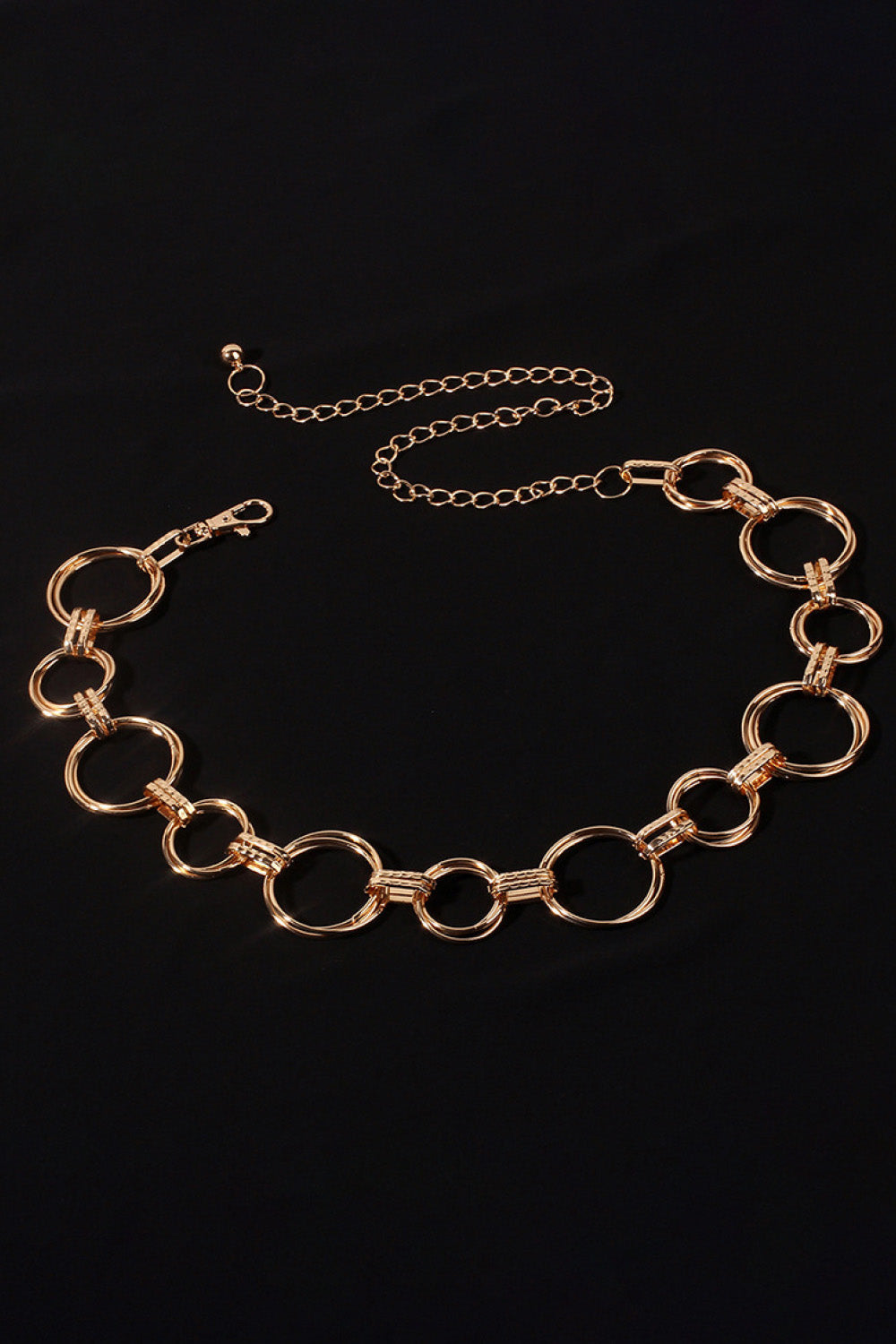 Gold alloy linked circle waist chain with lobster clasp and extender.