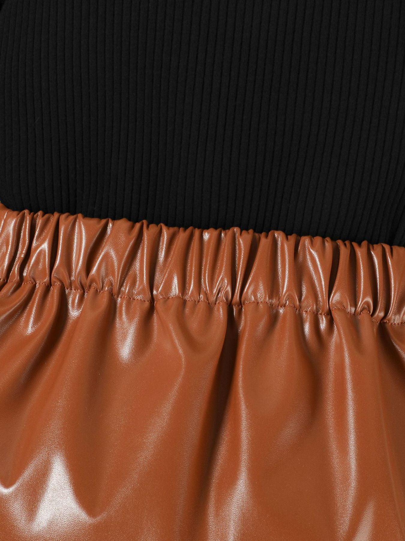 Black ribbed top with brown faux leather skirt featuring elastic waistband.