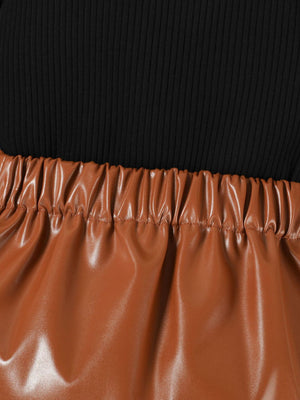 Black ribbed top with brown faux leather skirt featuring elastic waistband.
