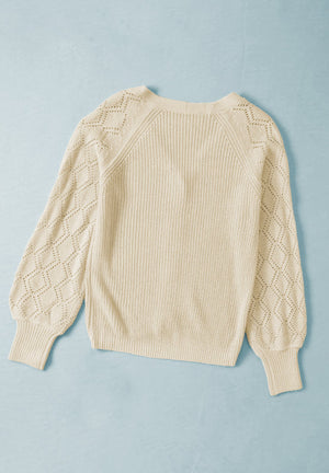 Cream diamond-cut sleeve knit cardigan with ribbed cuffs and neckline.