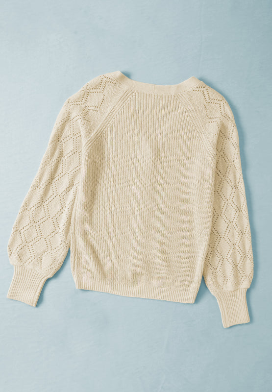 Cream diamond-cut sleeve knit cardigan with ribbed cuffs and neckline.