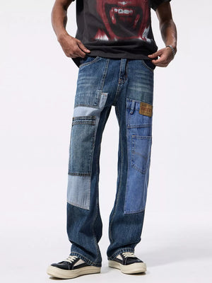 Relaxed fit jeans with a distinctive blue denim patchwork design and distressed details.
