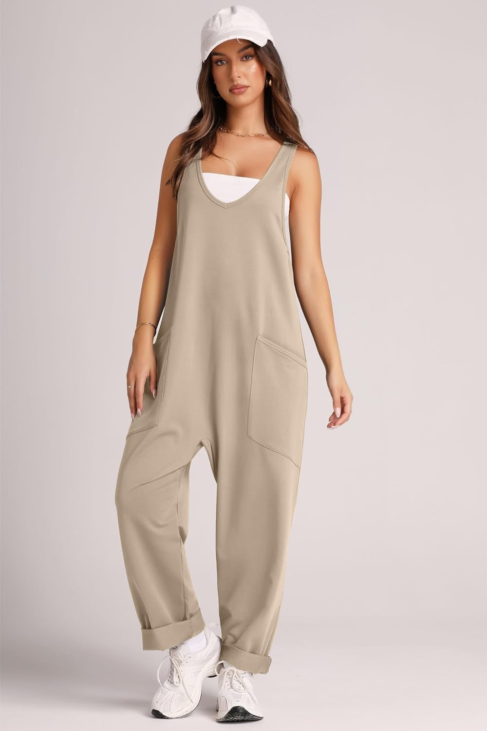 Khaki relaxed fit jumpsuit with v-neck, oversized pockets, and cuffed hems.