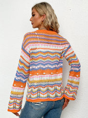 Rainbow chevron knit cardigan with openwork detail and orange trim.