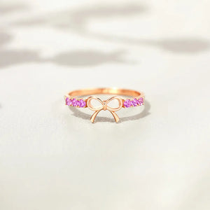 Rose gold ring with bow detail and pink gemstones