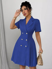 Blue double-breasted pleated blazer dress with gold buttons and short sleeves.