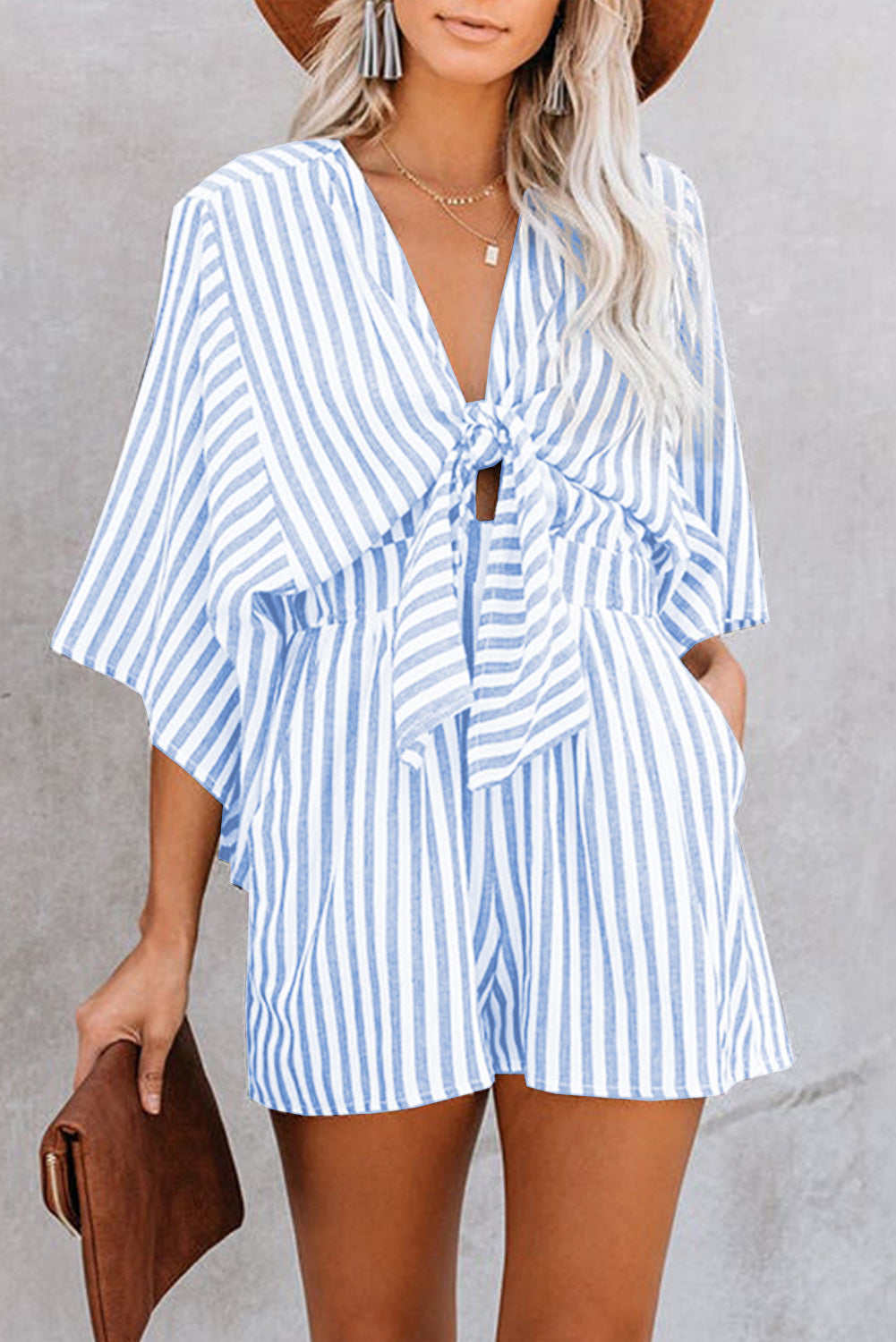 Light blue striped tie-front kimono jumpsuit with wide sleeves and shorts.