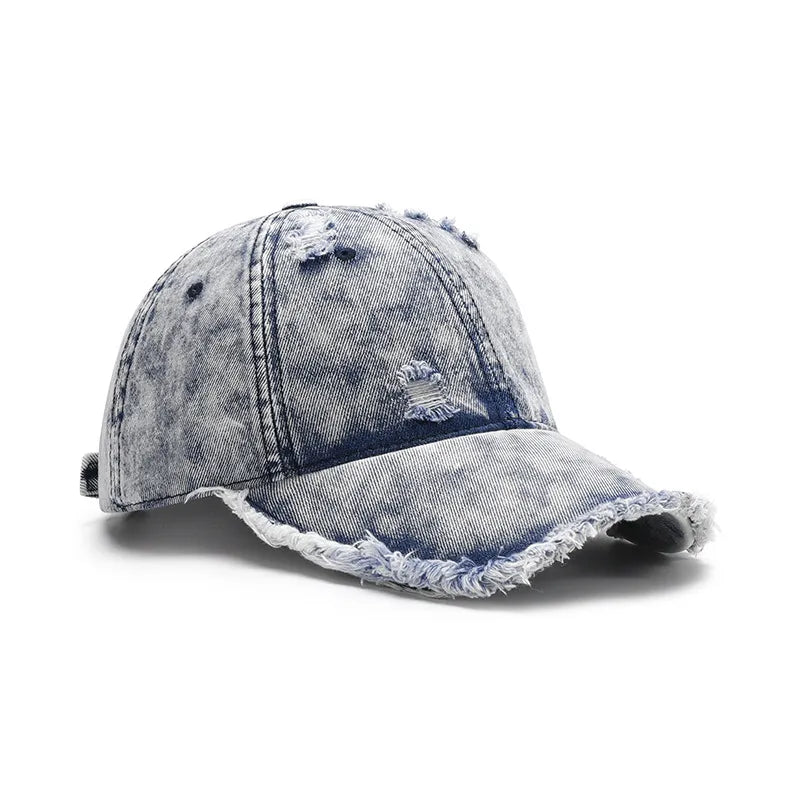 Acid wash frayed denim baseball cap with distressed details and raw edge brim.