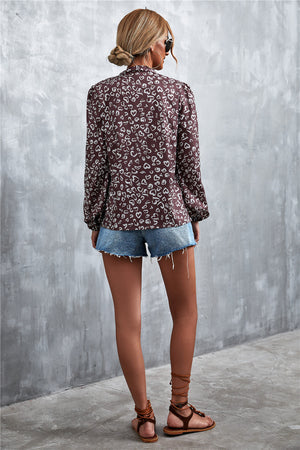 Brown abstract print blouse with pussy bow and balloon sleeves, styled with denim shorts.