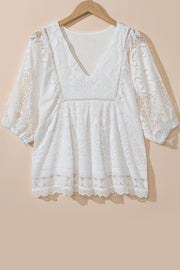 White lace peplum blouse with V-neck, 3/4 sleeves, and scalloped hem detail.