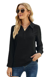 Black textured collared blouse with button placket and long sleeves.