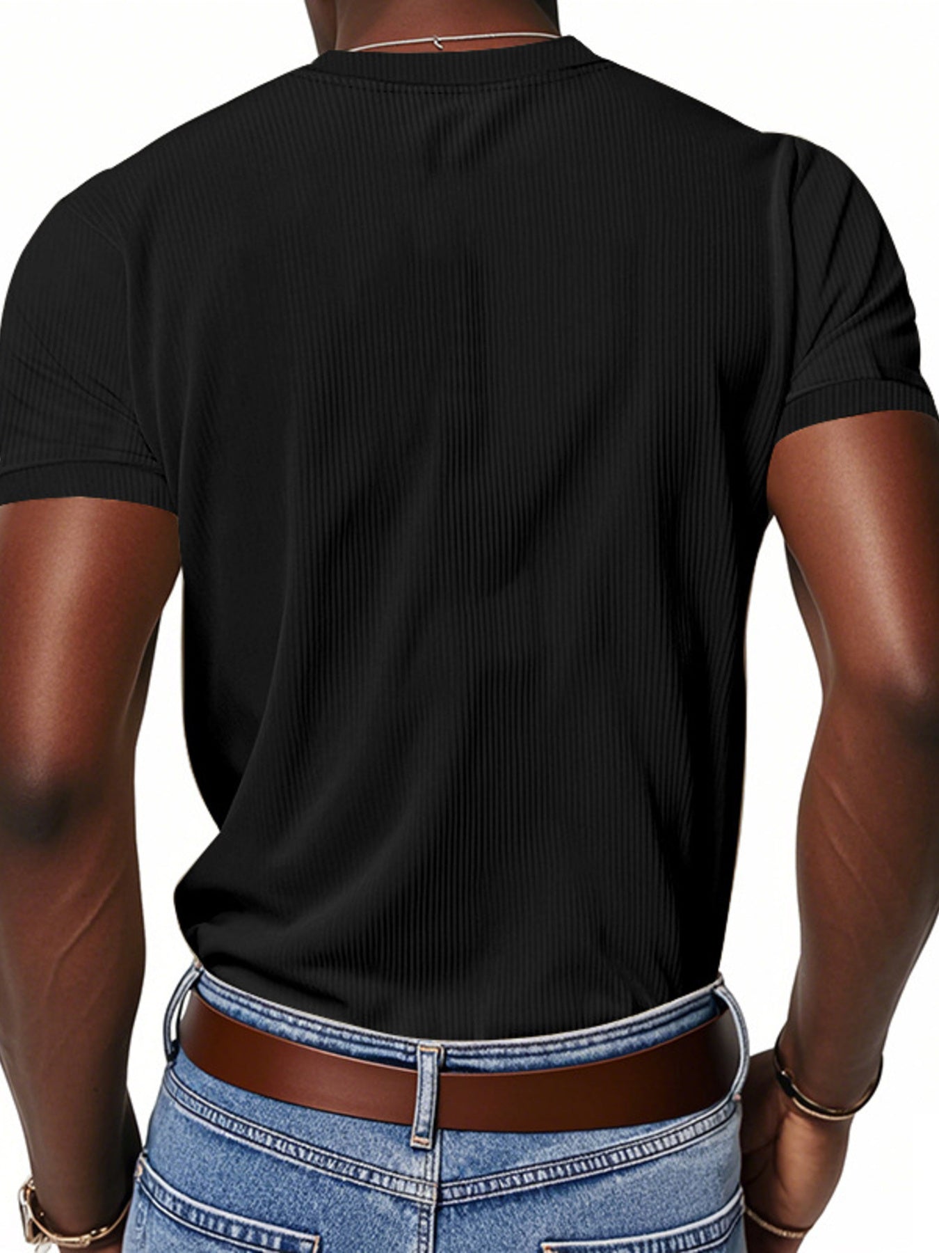 Black ribbed V-neck t-shirt with short sleeves on a man.